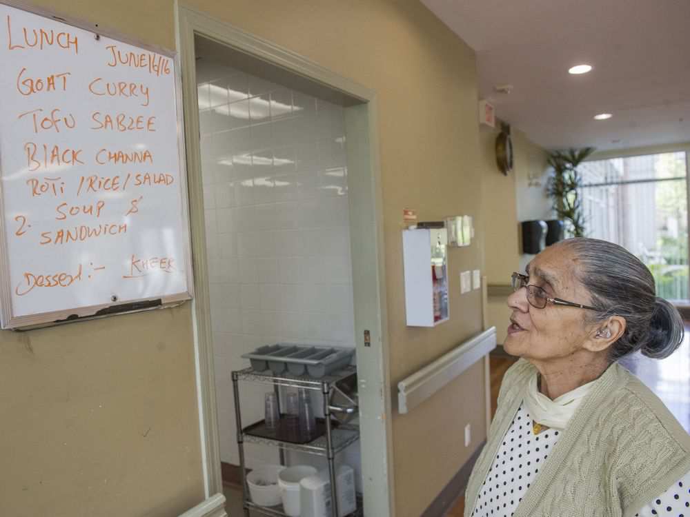 Resident Saroj Sood peruses the day's lunch menu at the Guru Nanak Niwas senior home in Surrey. 'Food is most important' as a cultural consideration for the residents.