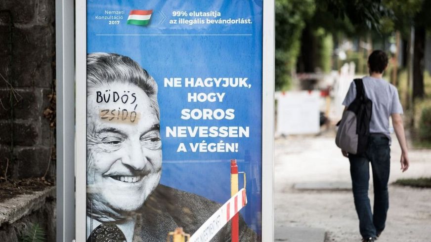 A poster showing George Soros, on which someone has written 